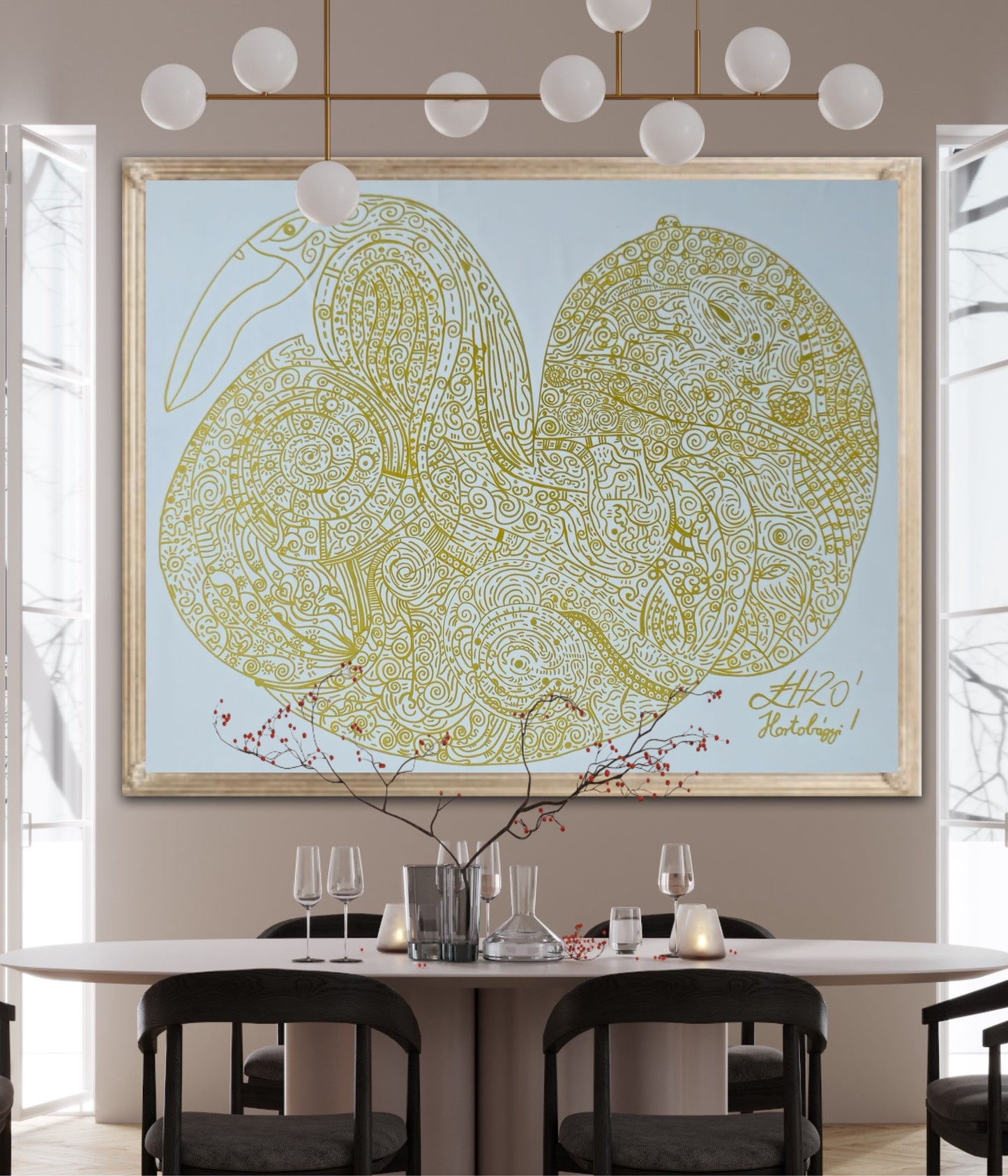 Decorative wall art of two stylized raven in a gold frame on a beige wall above a dining table.